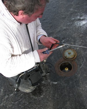 image of Len checking a monitoring well